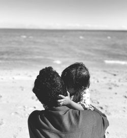 Rear view of a boy on beach