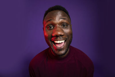 Portrait of a smiling man against blue background