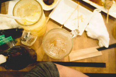 High angle view of drinks and chopsticks on table