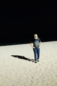 Full length of girl standing on sand at beach