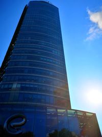 Low angle view of modern building against blue sky