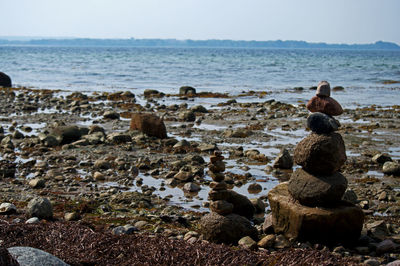 Rocks on beach against sky