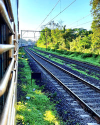 Railroad tracks by train against sky