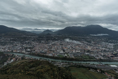 High angle view of river and townscape against sky