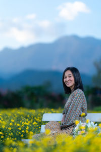 Portrait of a smiling young woman on field