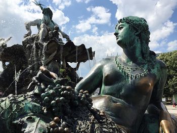 Low angle view of statue against cloudy sky