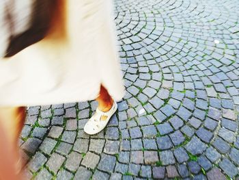 Low section of woman walking on footpath