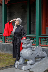Portrait of woman standing in city