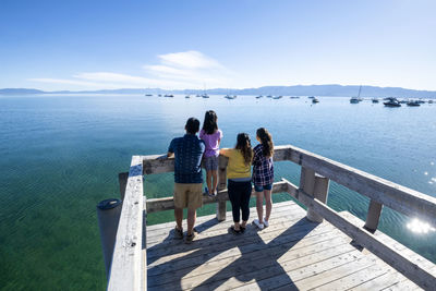 A family relaxes on a pier on a beautiful day in south lake tahoe, ca