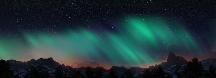 Scenic view of snowcapped mountains against sky at night