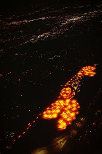 Close-up of illuminated fire against sky at night