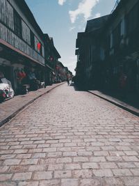 Street amidst buildings in city against sky