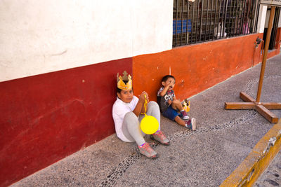 High angle view of girls sitting with toy