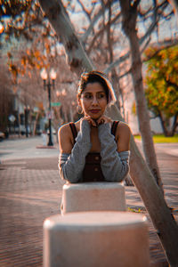 Portrait of young woman sitting outdoors