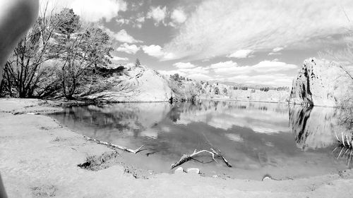 Scenic view of lake against sky during winter