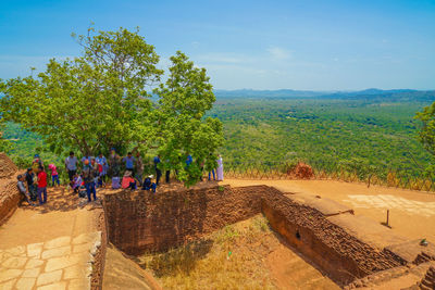 Group of people on landscape against the sky