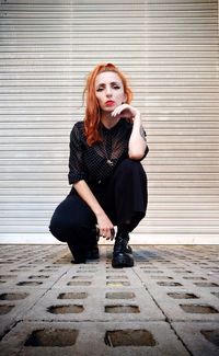 Portrait of young woman sitting outdoors