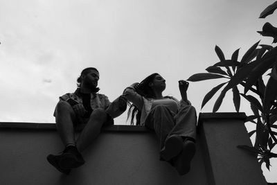 Low angle view of woman sitting on chair