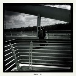 Silhouette of woman against cloudy sky