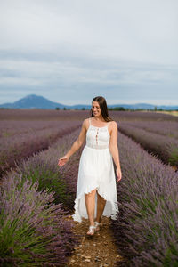 Full length of woman standing on land against sky