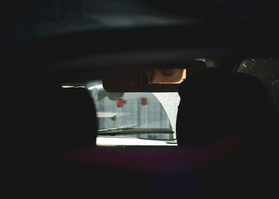 Reflection of man in car window