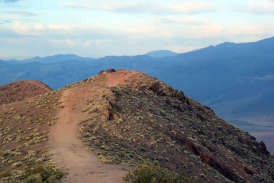 Scenic view of rocky mountain trail against sky