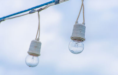 Close-up of water hanging against sky