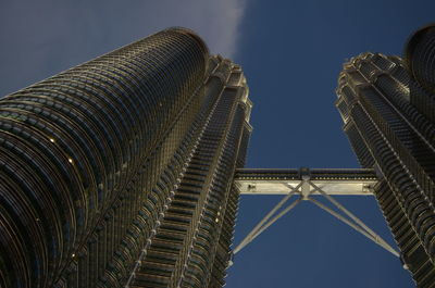 Low angle view of petronas towers against sky at night