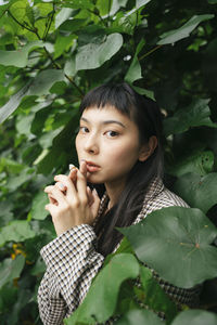 Portrait of young woman with leaves