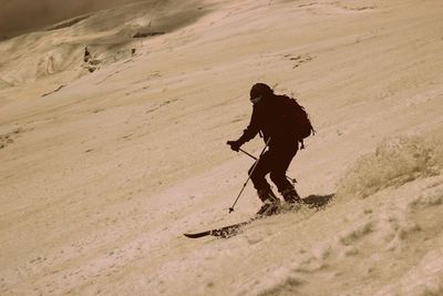 Man skiing on sand