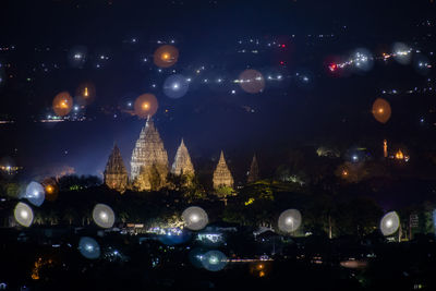 Illuminated buildings in city at night