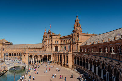 Low angle view of historical building against clear blue sky