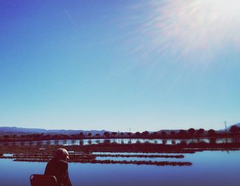 Calm lake against blue sky