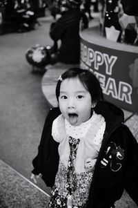 High angle view of a girl sticking out tongue