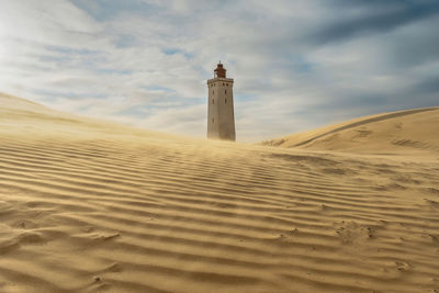 Abandoned lighthouse dyring sand storm