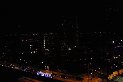 Illuminated city against sky at night