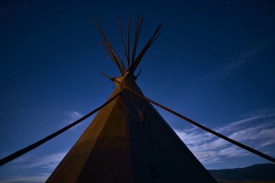 Low angle view of wind turbine at night