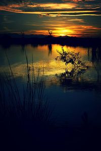 Scenic view of lake at sunset