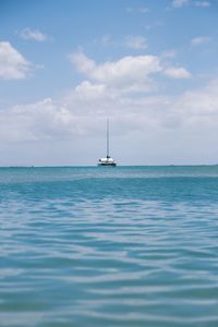 Sailboat in sea against sky