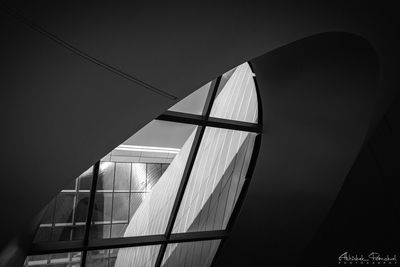 Low angle view of illuminated building against sky at night