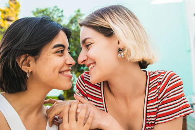 Close-up of smiling couple embracing outdoors