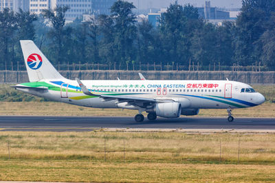 Side view of airplane on field