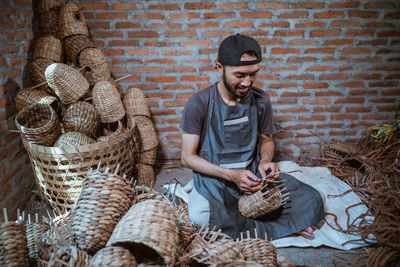 Portrait of senior man standing in wicker basket