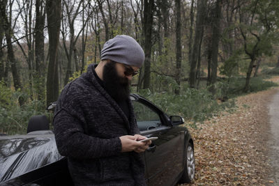 Man wearing sunglasses in forest