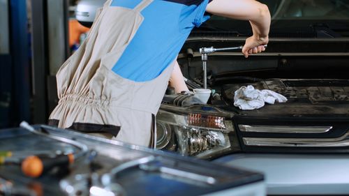 Midsection of man working in workshop