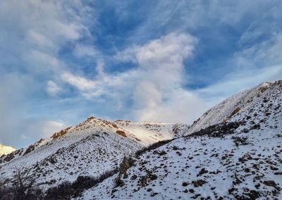 Low angle view of snowcapped mountain against sky