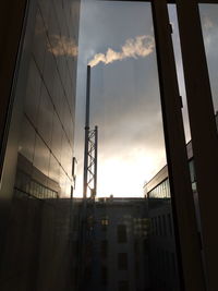 Low angle view of silhouette buildings against sky at sunset