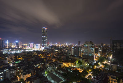 High angle view of illuminated buildings against sky at night