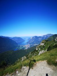 Scenic view of mountains against clear blue sky