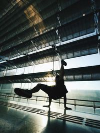 Silhouette man dancing on floor